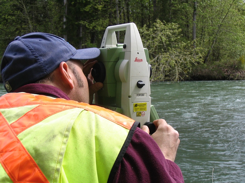 surveyor sighting next to river
